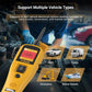 Automotive electrical circuit diagnostic tester with display and connected leads beside engine bay