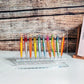 Clear acrylic lure organizer displaying multiple colorful fishing lures in slots