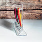 Angled clear acrylic lure display stand showing lures hooked on front pegs