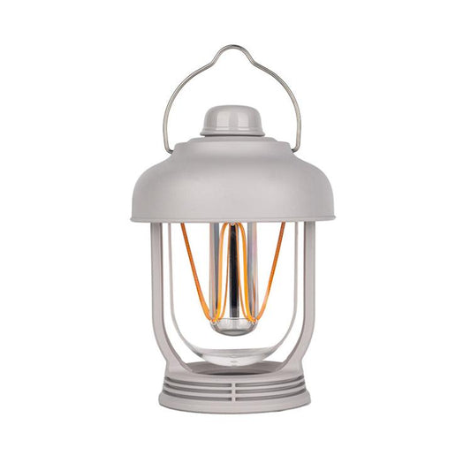 Light gray portable camping lantern with hanging handle and glowing filament bulbs