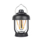 Black portable camping lantern with hanging handle and glowing filament bulbs
