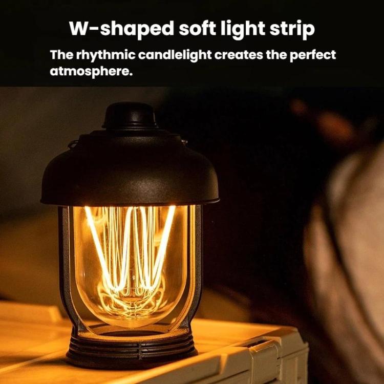 Black portable camping lantern with warm glowing filament bulbs inside clear glass