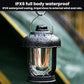 Black waterproof camping lantern with water droplets on glass and warm glowing bulbs