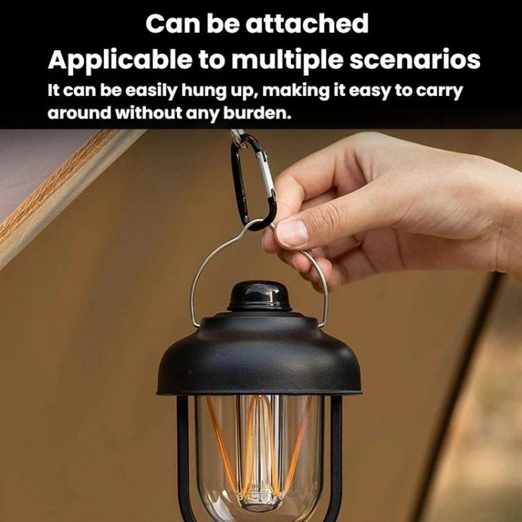 Black portable camping lantern with hanging handle and warm glowing filament bulbs