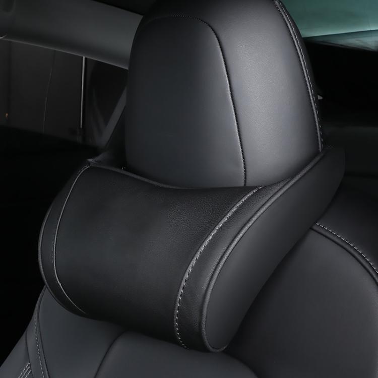 Leather seat neck pillow in black with curved bolster and stitched trim on headrest