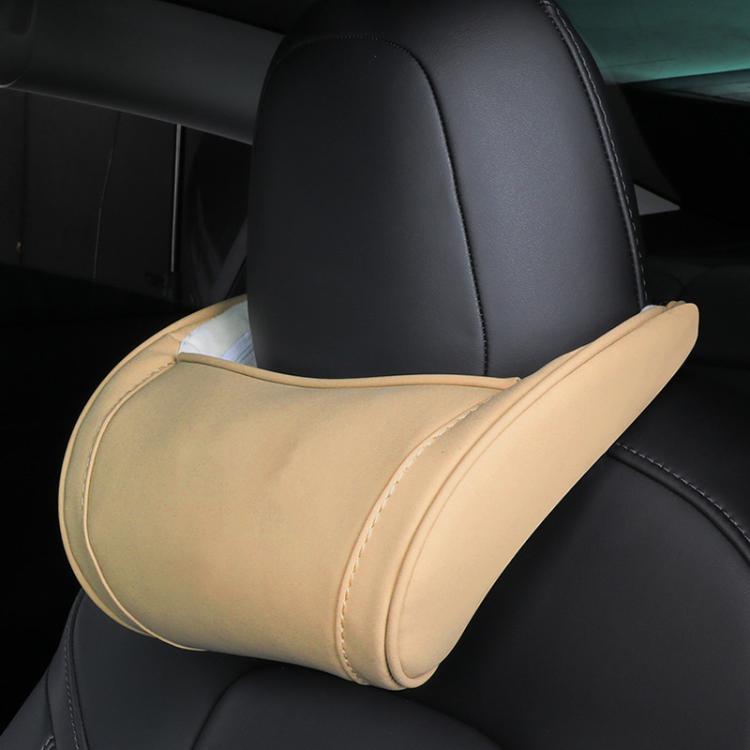Beige leather seat neck pillow with light edge stitching on car headrest