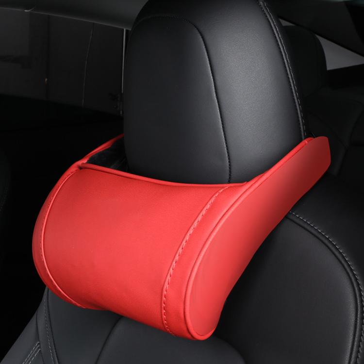 Red leather seat neck pillow with white edge stitching on car headrest