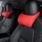 Red leather seat neck pillow on front car seat headrest with stitched bolster