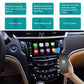 Smartphone held near in-car display showing app icons on a connected screen