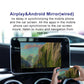 Car infotainment screen showing mirrored content while a smartphone is held nearby