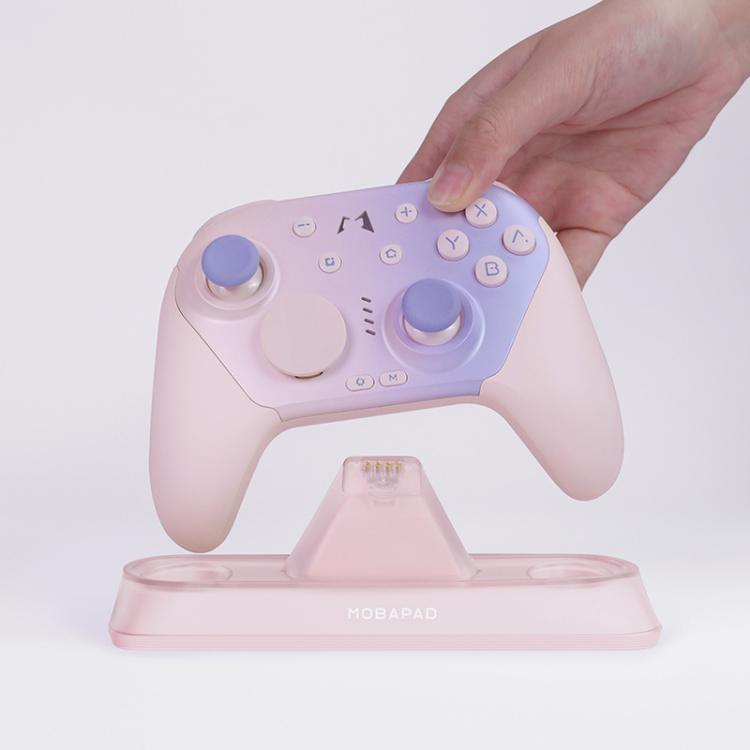 Pink controller charging dock with controller placed on the central cradle