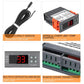 Digital temperature controller with attached sensor cable and orange terminal cover, detail view
