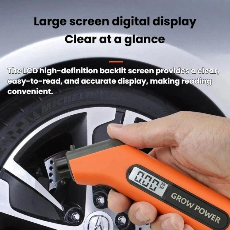 Hand holding orange tire pressure gauge with LCD digital display