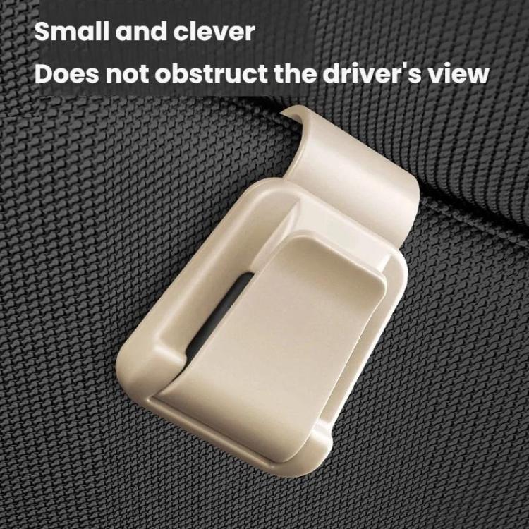 Beige car sunglasses clip ticket and card holder clipped onto textured surface.
