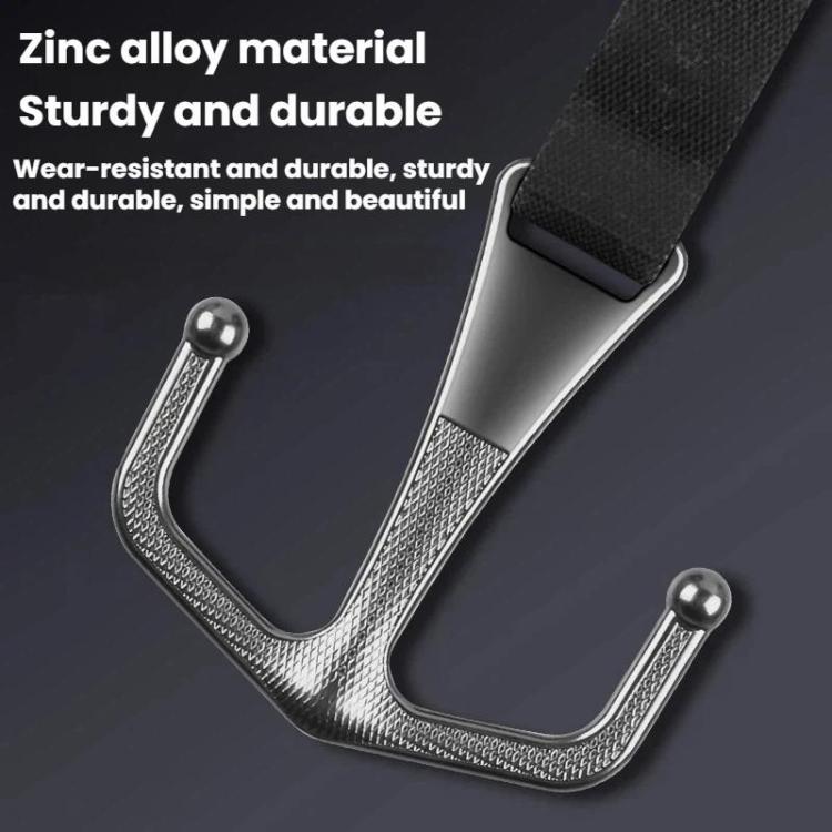 Close-up of U-shaped metal motorcycle front hook with dark strap and textured posts
