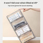 Clear drawer organizer tipped open at an angle with interior trays and dividers