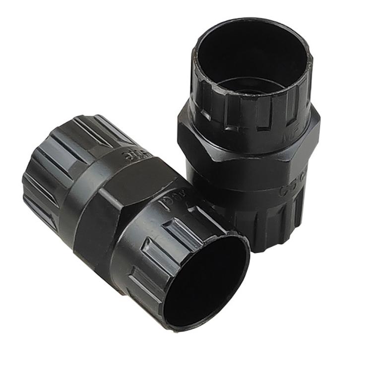 Black two-piece freewheel socket tool adapter, angled close-up.
