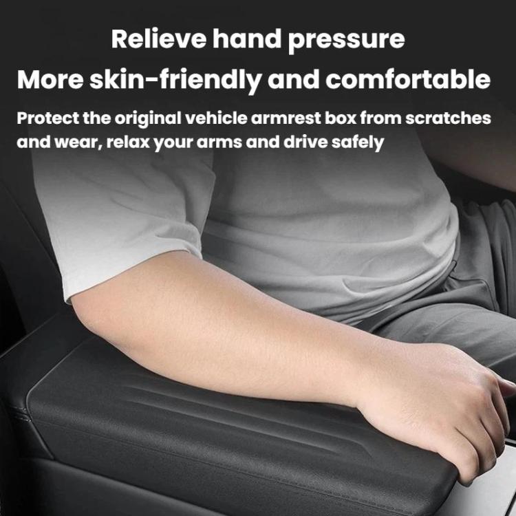 Black armrest box dust cover with ridged surface protecting the center console
