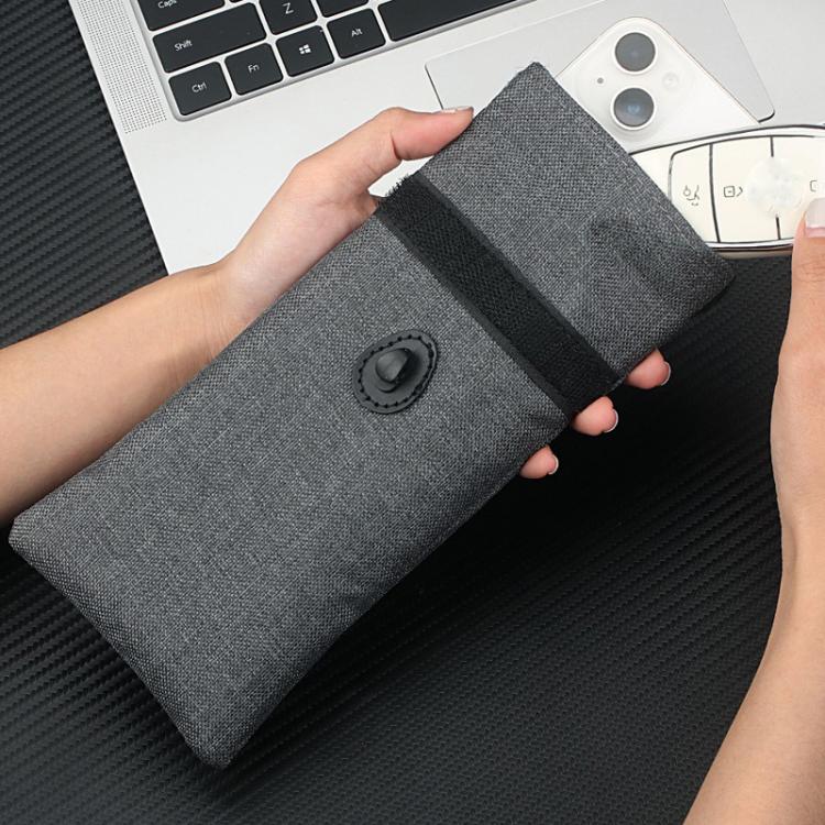 Gray foldable pouch with snap button and drawstring, held in hand