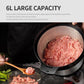 Large stainless steel grinding bowl filled with chopped meat, black rim base