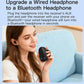Black Bluetooth receiver upgrading a wired headphone via 3.5mm AUX plug