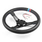 Black steering wheel with center hub, 3 spokes, and blue/red stitched rim detail
