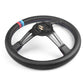 Black microfiber steering wheel with blue/red stitched rim and exposed rear mounting plate
