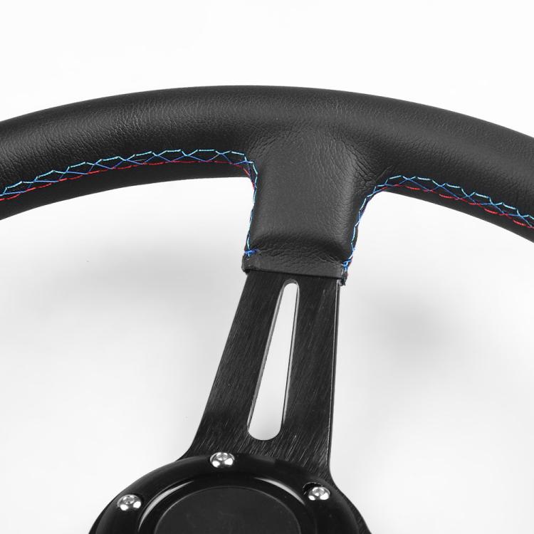Steering wheel grip close-up with blue/red stitching and metal spoke support