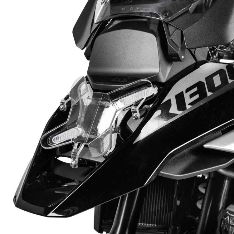 Clear headlight protector over motorcycle headlamp with metal mounting brackets