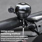 Silver bike thumb bell mounted on a handlebar with side button