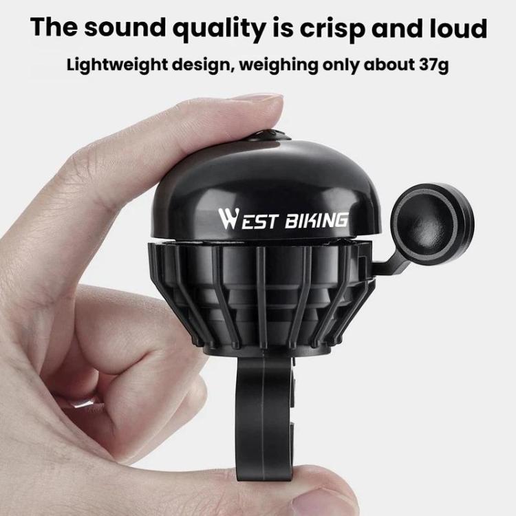 Black bike thumb bell with side button, held by hand for quick pressing