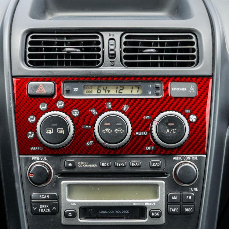 Red carbon-fiber air conditioning control panel sticker on vehicle dashboard controls