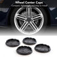 Set of 4 black wheel center caps with one shown on a silver alloy wheel rim