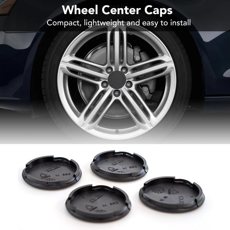 Set of 4 black wheel center caps with one shown on a silver alloy wheel rim