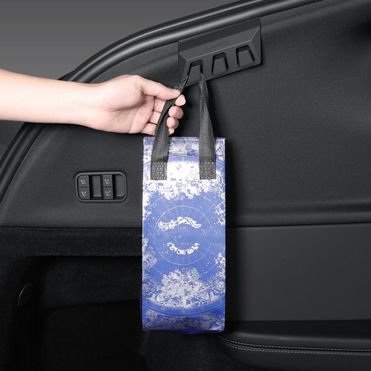 Black concealed trunk hooks holding a shopping bag by two hanging hooks