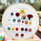Embroidery hoop sampler with beginner stitch designs and colorful raised flower stitches