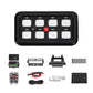 Black spotlight control switch panel with eight hex push buttons and red power symbol