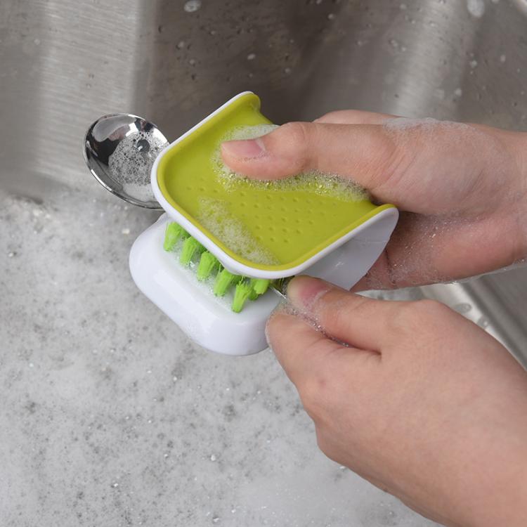 U-shaped scrub brush cleaning spoon under running water