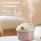 Pink mini house desktop humidifier with orange-lit window and steam mist