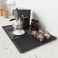 Dark gray silicone draining tray mat with raised horizontal ridges for coffee machine