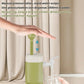 Green portable water pressurizer being pressed, with water flowing into a cup