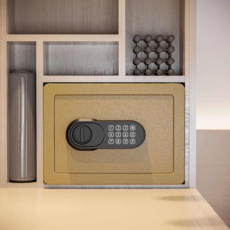 Gold concealed wall safe installed in a wall niche with key lock and keypad.