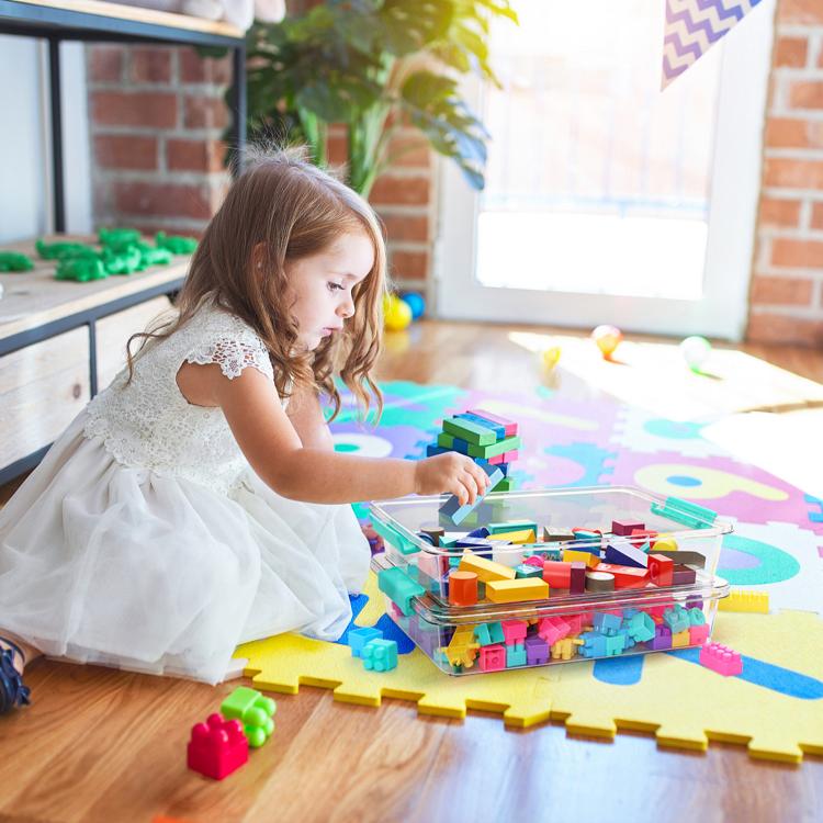 Clear plastic storage box with teal latch for building blocks during play