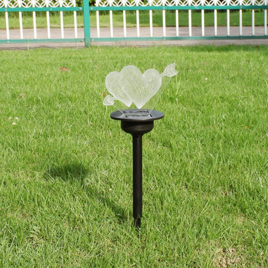 Solar ground spike light with heart-shaped topper on round black head and pointed stake