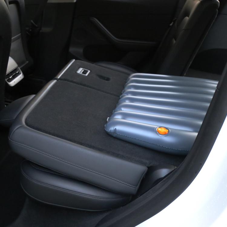 Inflated blue car air bed ramp mat in the back seat/trunk area