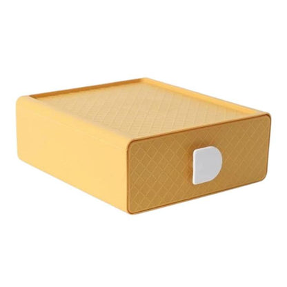 Yellow plastic drawer organizer with diamond-textured sides and white handle cutout