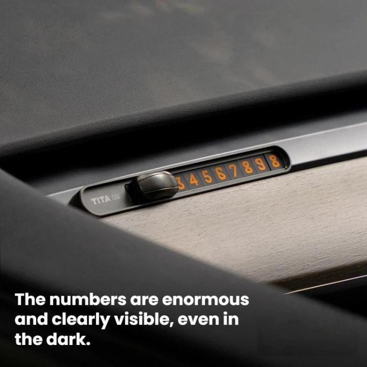 Temporary parking number plate installed in car interior with orange digits visible
