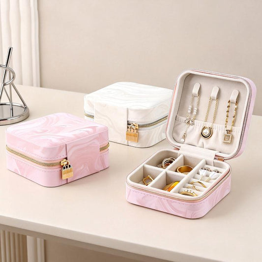 Opened travel jewelry organizer pouch with compartments holding necklaces, rings, and earrings.