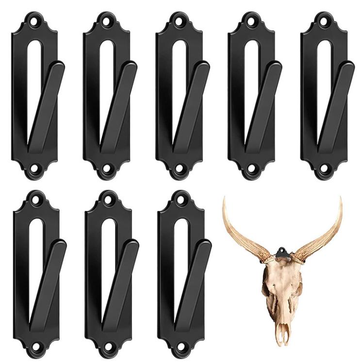 Black metal wall mount bracket hooks with oval openings, mounted animal skulls