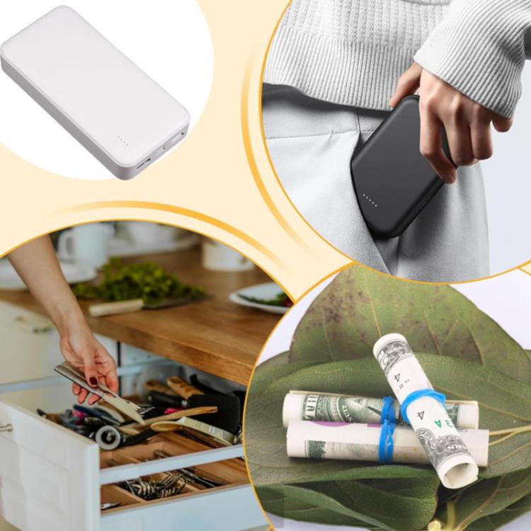 Black power bank-shaped hidden storage box held by hand near a drawer
